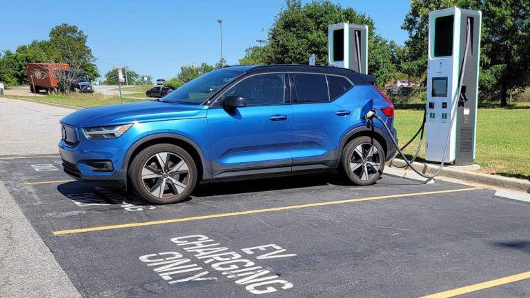 Blue Volvo Recharge at a charging station